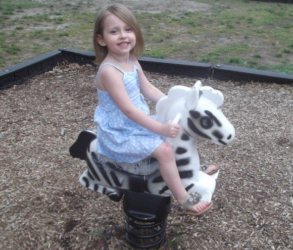 My daughter on the Zebra at the park.