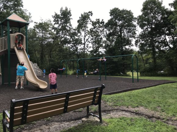 A view of a slide and the traditional swings at the Loop Playground in Mountainside.