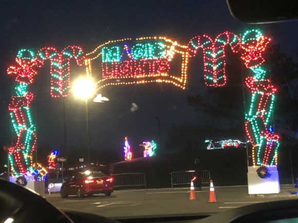 Cars begin their drive through the Magic of Lights under this lit display at the PNC Bank Arts Center in Holmdel
