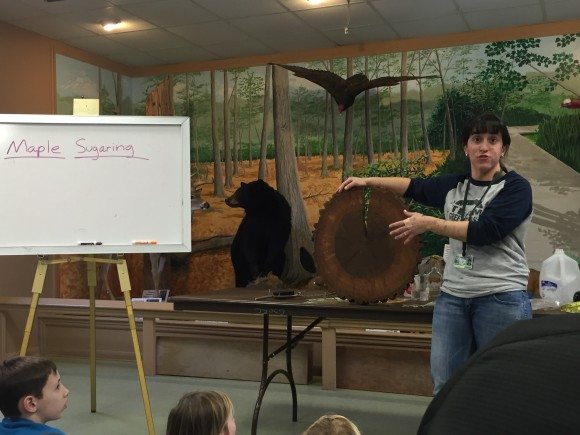 Stephanie explains the tree cookie and parts of the tree at Great Swamp Outdoor Education Center