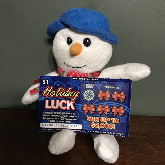 New Jersey Lottery Tickets as a git sitting with a stuffed snowman