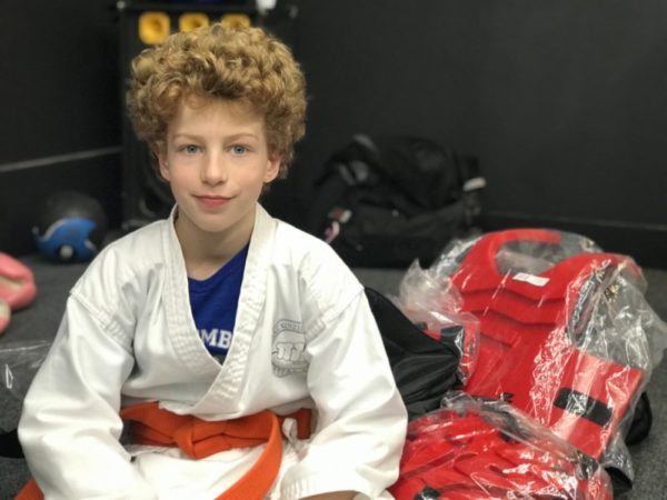 Mackenzie & Yates Martial Arts karate kid with sparring equipment
