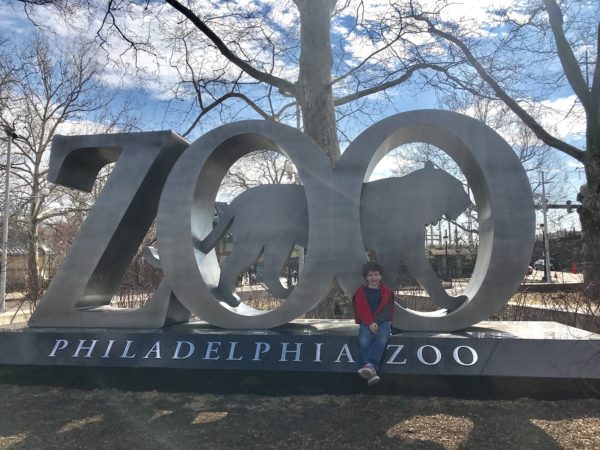 Image of child with the Philadelphia Zoo sculpture