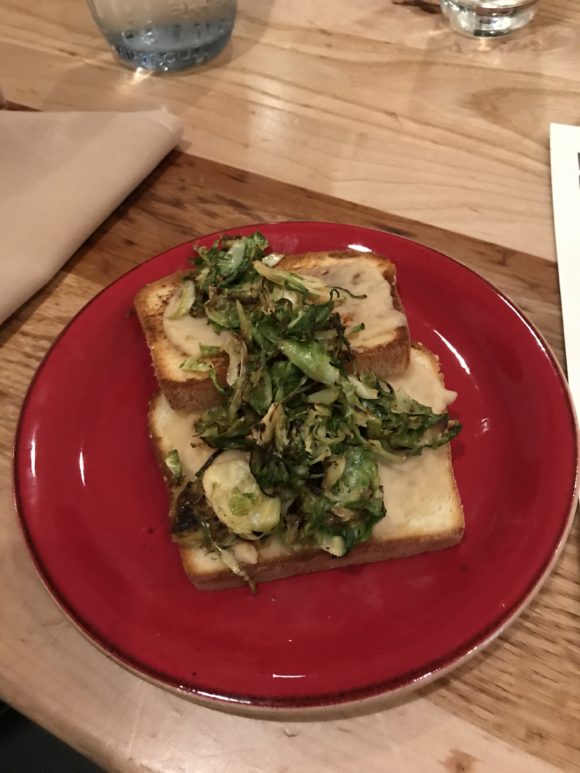 White Bean & Roasted Garlic Hummus with Shaved Brussel Sprouts Toast, a gluten-free option available at the Fire & Grain restaurant at the Hershey Lodge.