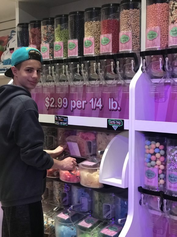 Teen in Iplay America candy shop