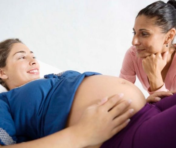 hispanic pregnant woman with hispanic female nurse 