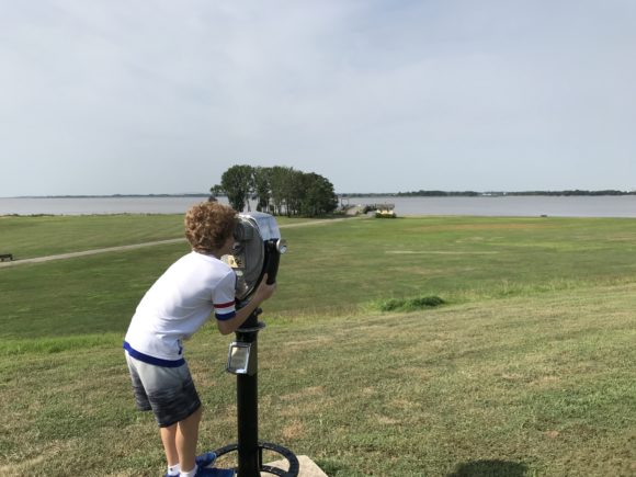 boy looks at Delaware River through viewfinder