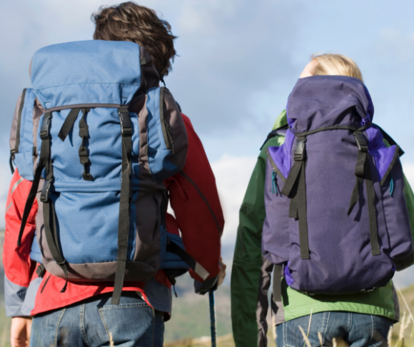 hiking female and male with backpacks on.
