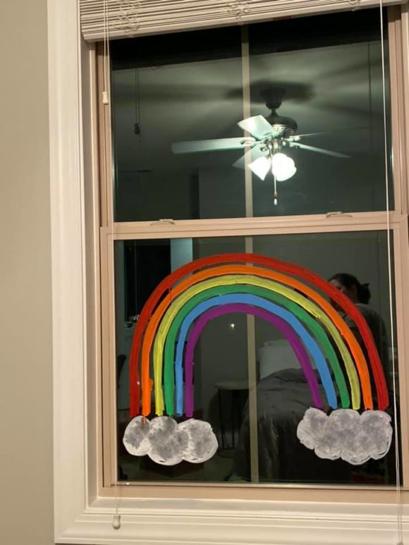 a house with a rainbow painted in the window