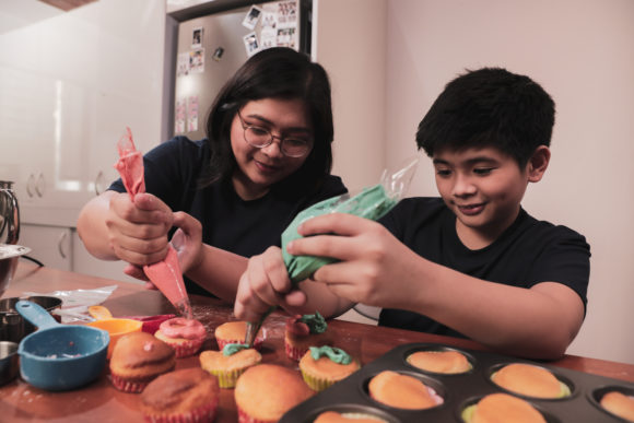 mother and son decorating cupcakes with a cupcake decorating kit from a NJ bakery.