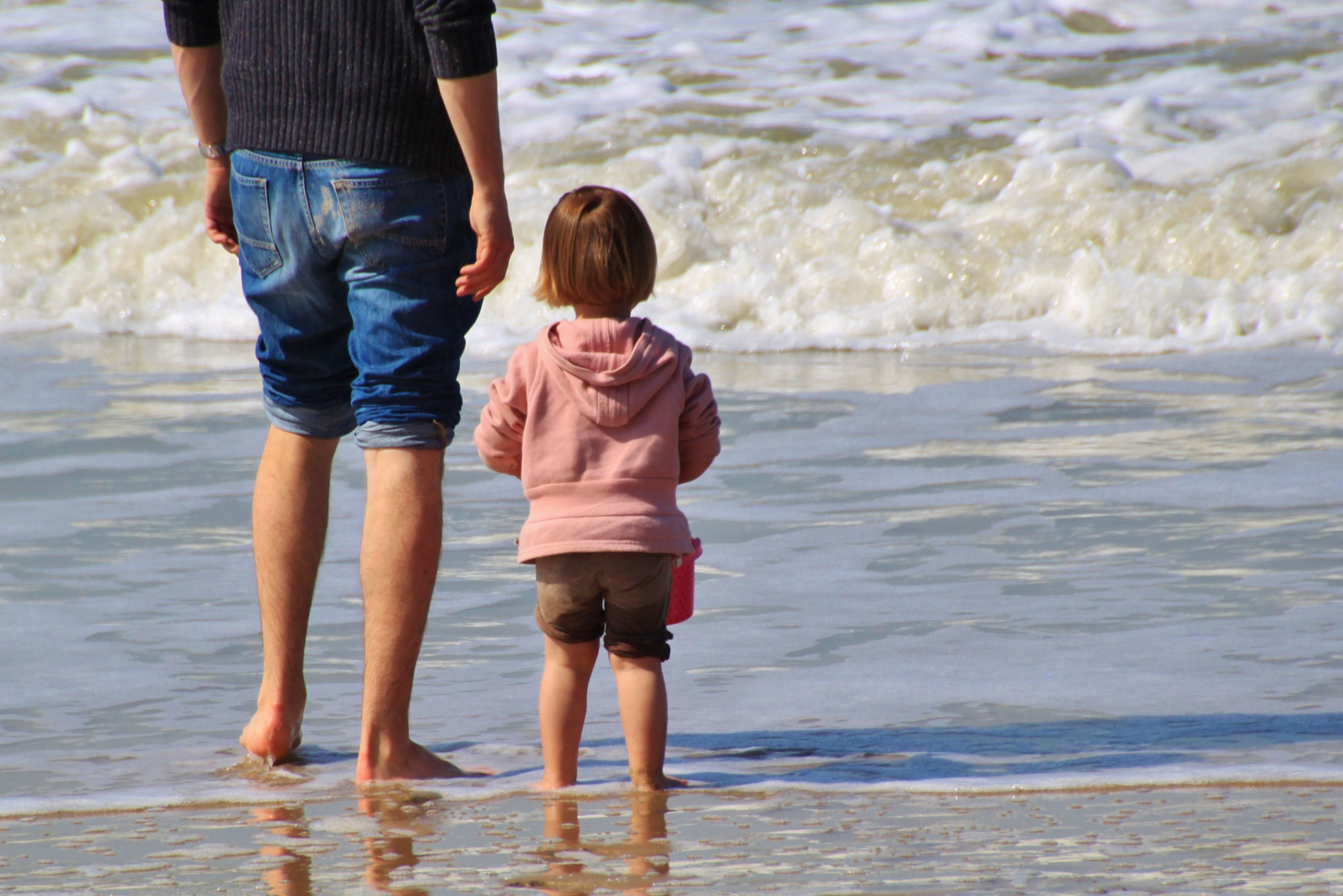 social distancing at the Jersey Shore beaches a father and child wade in the water