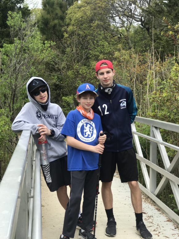 Three boys on bridge of a hiking trail - Cape May Point State Park