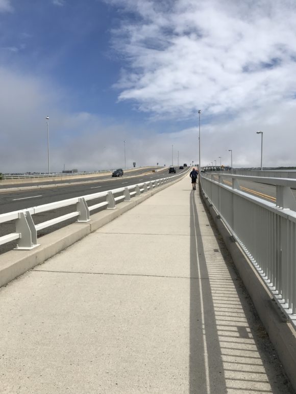 Teenager Walking across the Ocean City Bridge