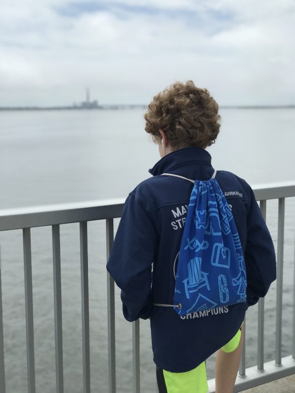 Boy looks out over the water at an observation point of the Ocean City Bridge pedestrian path.