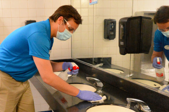 An employee cleans sinks at Six Flags Great Adventure