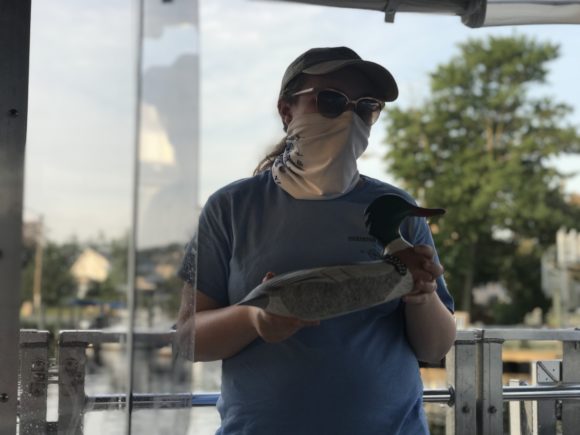 A Tuckerton Seaport intern leads a lesson in the floating classroom aboard the Tuckerton LBI Ferry.