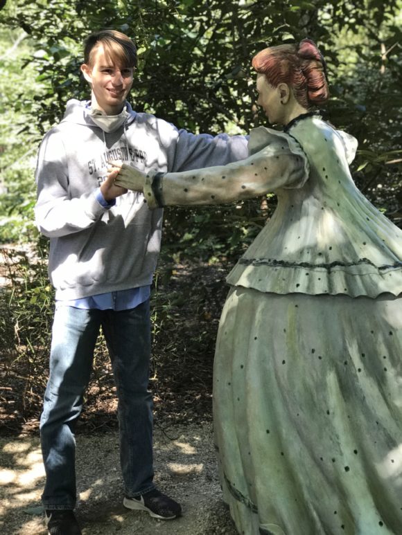 A teen dances with a sculpture at Grounds for Sculpture a wonderful New Jersey fall activity.