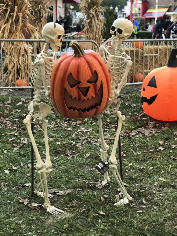 Skeletons with a jack o lantern at Six Flags Great Adventure Halloween activities in New Jersey