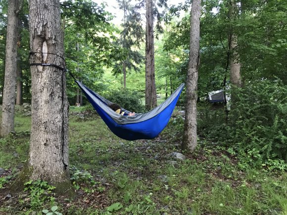 A bearbutt double hammock hangs from trees at a Stokes State Forest campsite