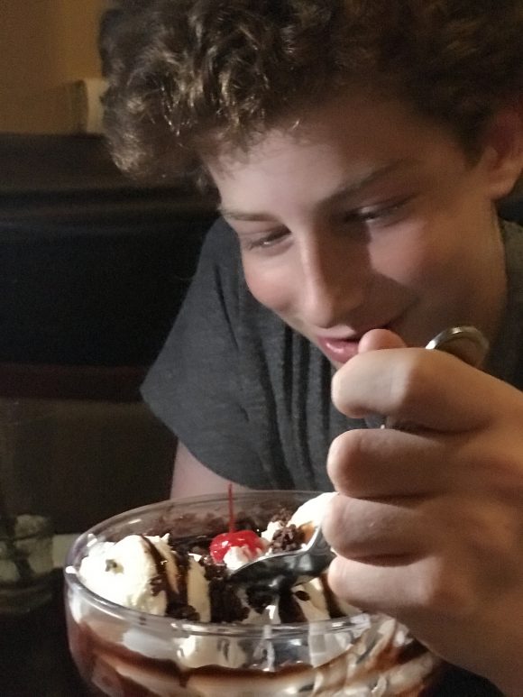 Boy digs into brownie ice cream sundae at Hard Rock Cafe Philadelphia