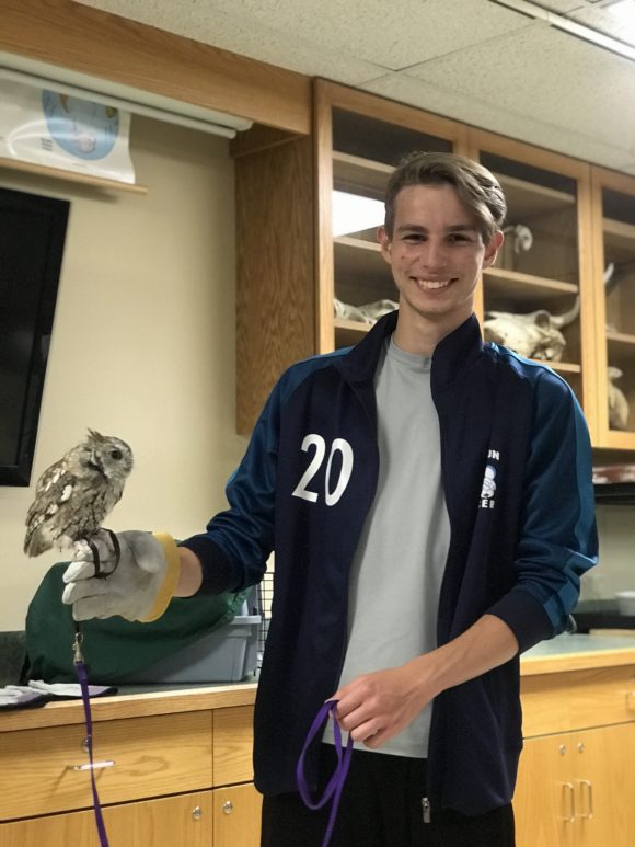 teen holds owl during ZooAmerica behind the scenes tour
