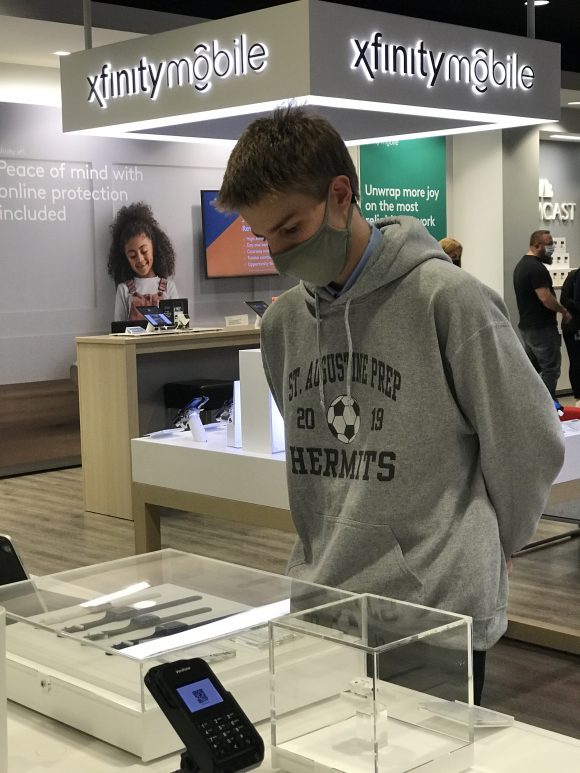 Teenager eyes up Apple Watches on sale at the Xfinity Store in Mays Landing NJ