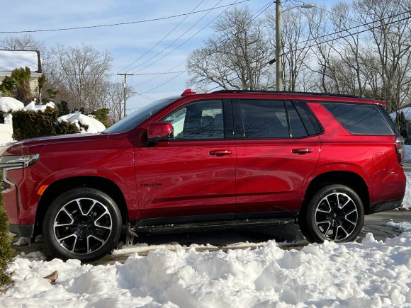2022 Red Chevy Tahoe parked in driveway after snow blizzard