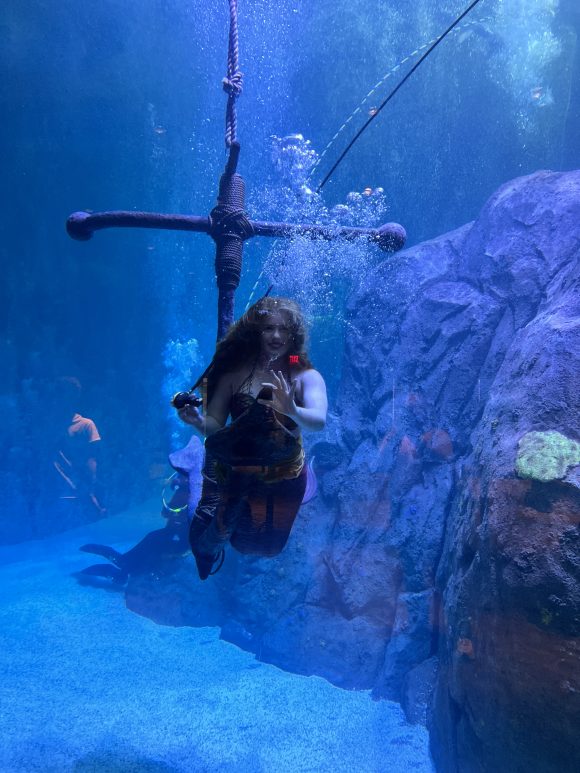 Underwater mermaid at Adventure Aquarium with exit reflection in hair