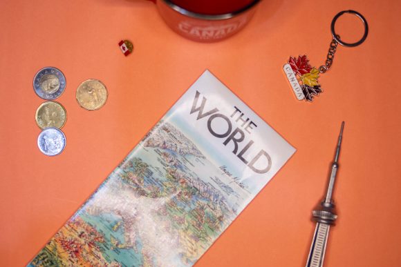 travel map and souvenirs on orange background