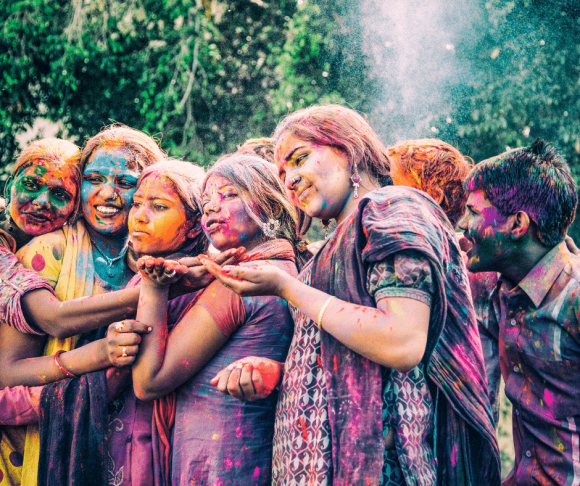A group of young Indians hugging during the Holi Festival, in Jaipur India. An example of a Holi Celebration near me in New Jersey NJ.