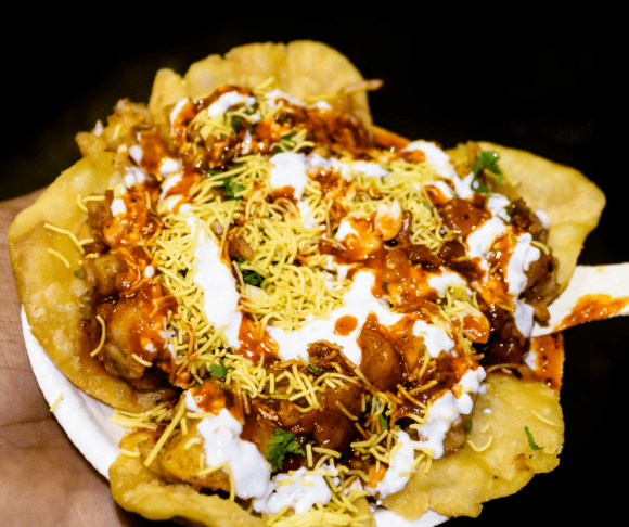Indian famous Papdi Chaat (Papri Chaat). A yummy snack assorted with crunchy base of Papdi (crisp puris) topped with lip-smacking chutneys, veggies and curd.