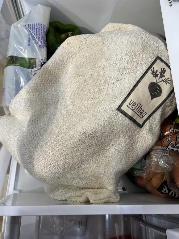 Vejibag vegetable preservation bag in a fridge drawer helps keep vegetables fresher longer.