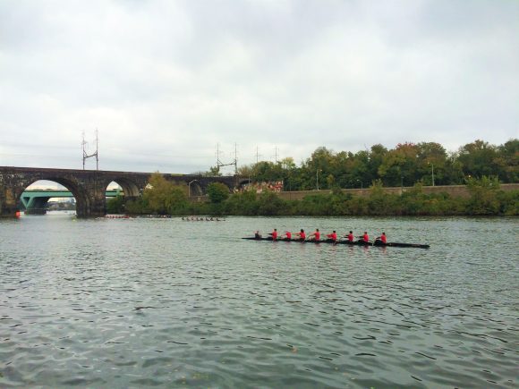 A Crew team rowing on the river at Boathouse Row in Philadelphia