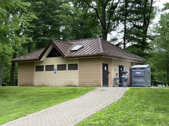Restroom building and port-a-potty at Ridgewood Saddle River County Park.