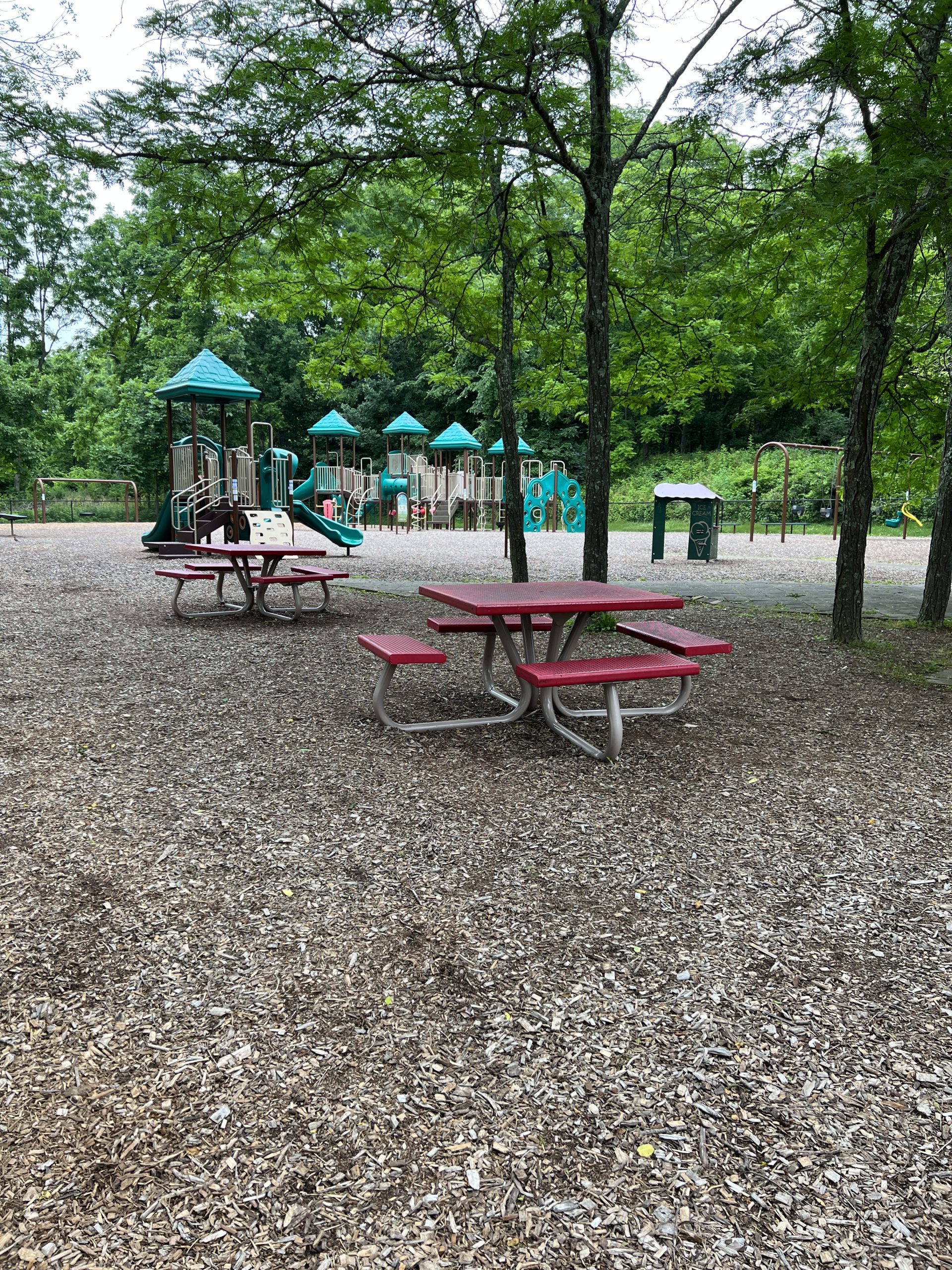 Vertical picture of FULL Kids Kastle Station Park Playgrounds with picnic tables in Sparta NJ