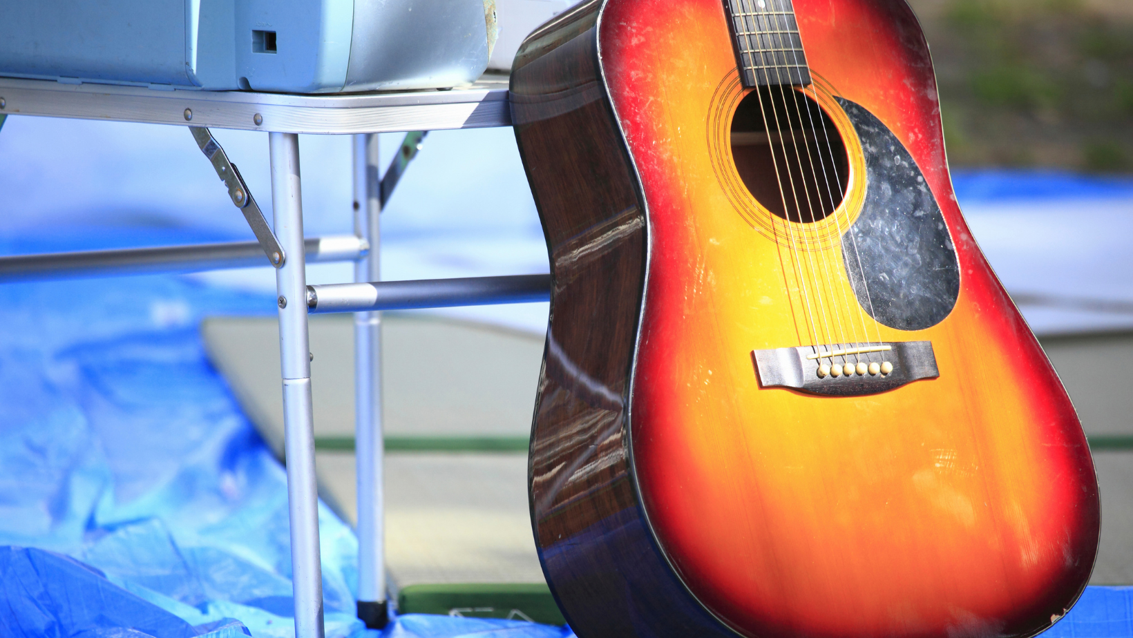guitar resting against table on stage at concert