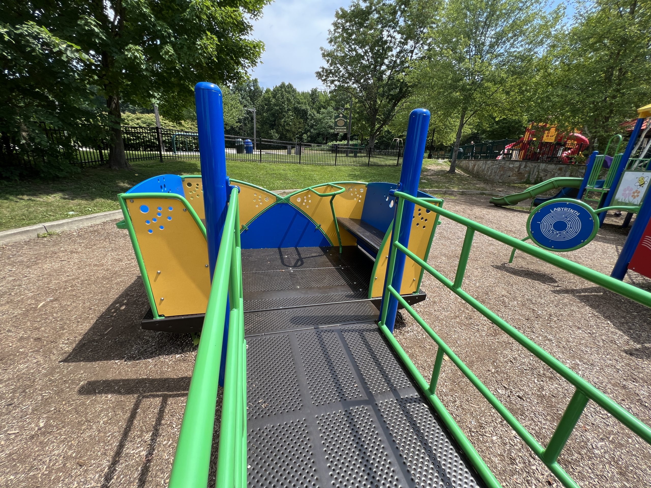 Blue and Green accessible playground wheelchair accessible cruiser 1 at Montville Community Playground in Montville NJ