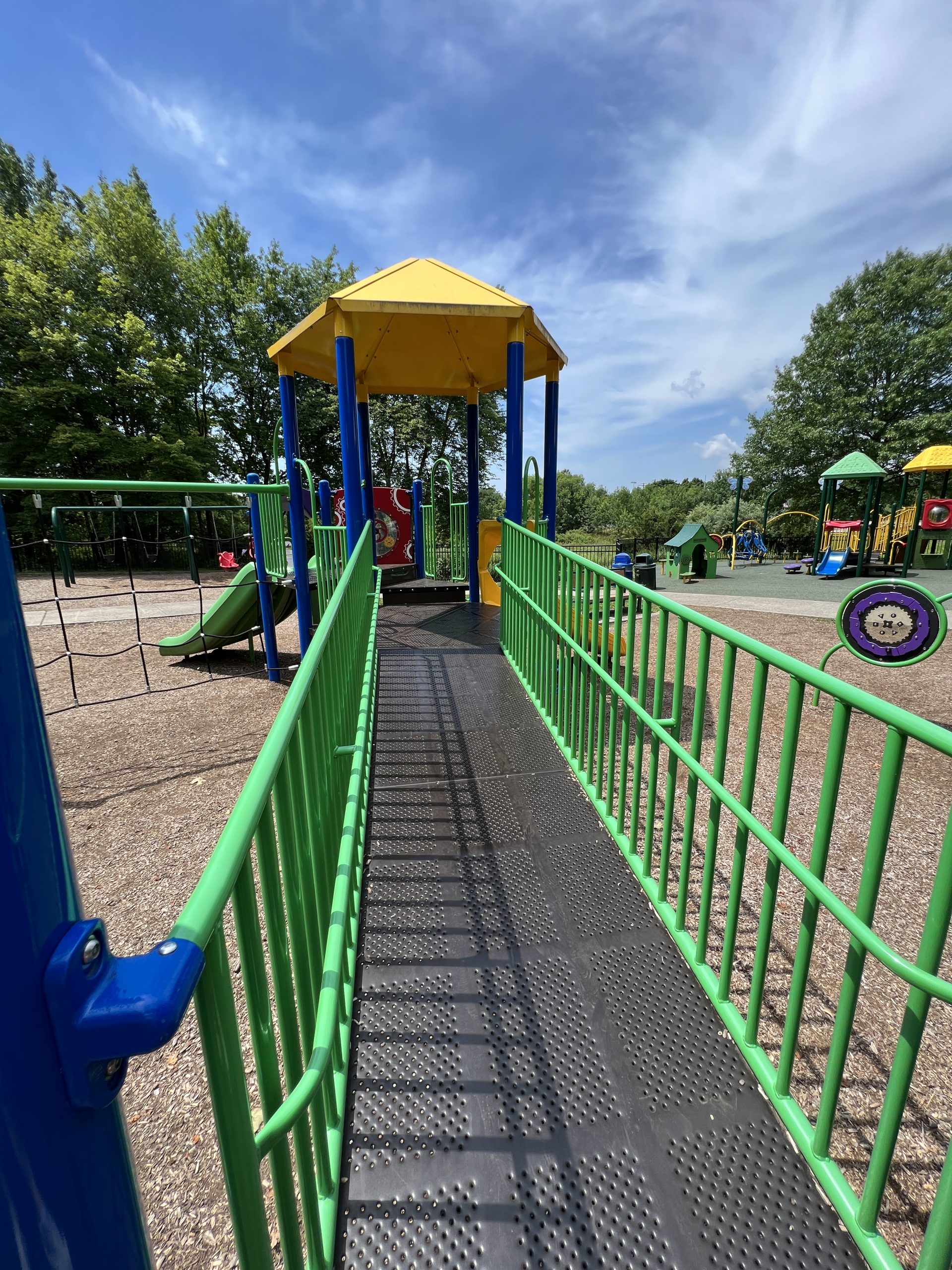 Blue and Green accessible playground wide ramp at Montville Community Playground in Montville NJ
