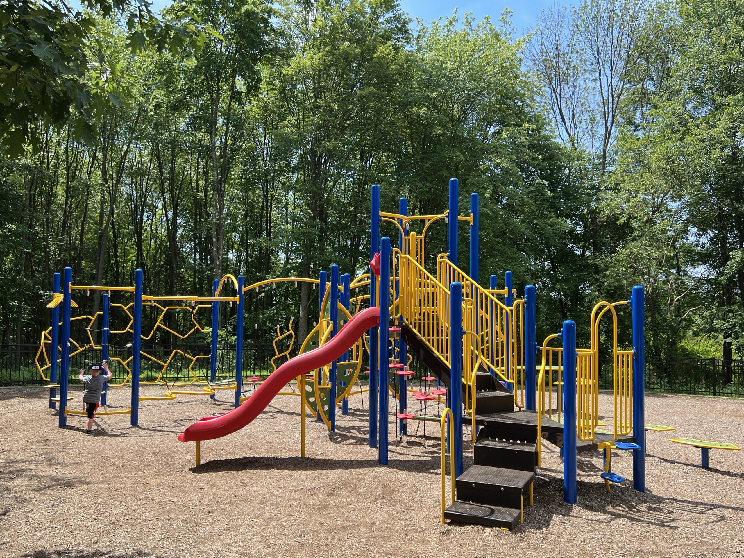 Blue and Yellow climbing playground at Montville Community Playground in Montville NJ WIDE shot slide side