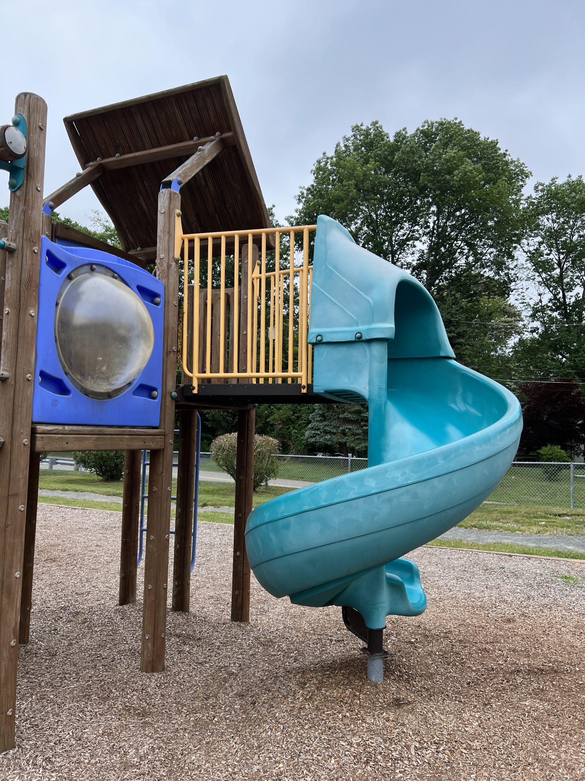 Green twisting slide at C O Johnson Park Playground in Byram Township NJ