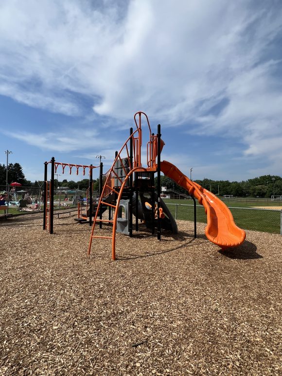 Hackettstown Community Park Playground in Hackettstown NJ Vertical picture of bigger structure with curvy slide climbing ladder and monkey bars