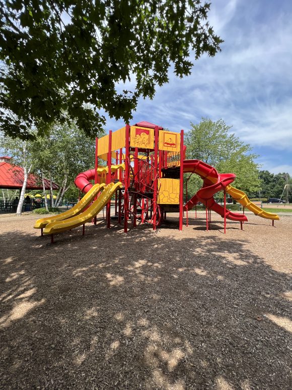 Red and Yellow barn playground at Montville Community Playground in Montville NJ TALL view BEST with all slides