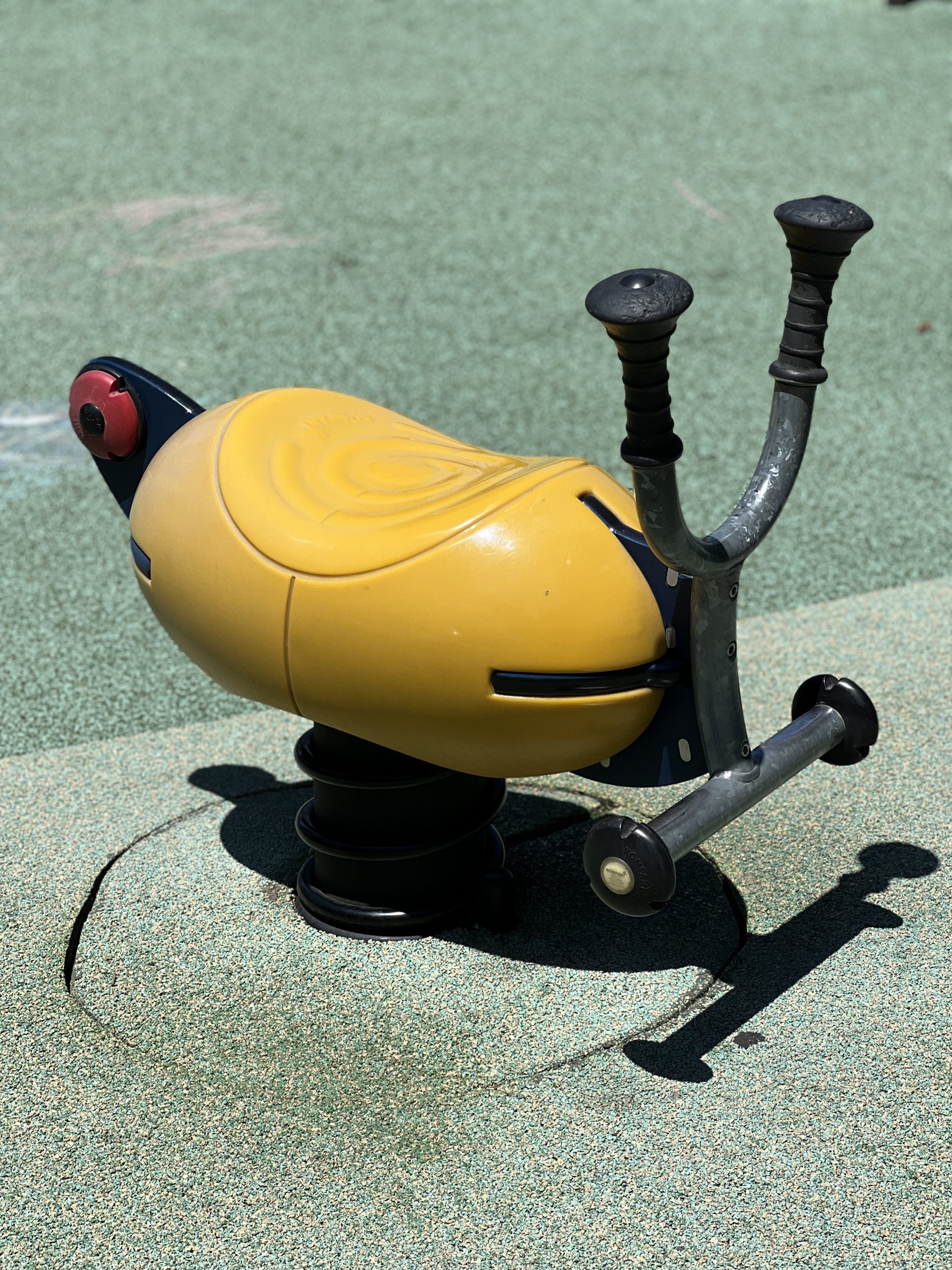 FEATURES - Ride on toy yellow AT Newport Green Park Playground in Jersey City NJ