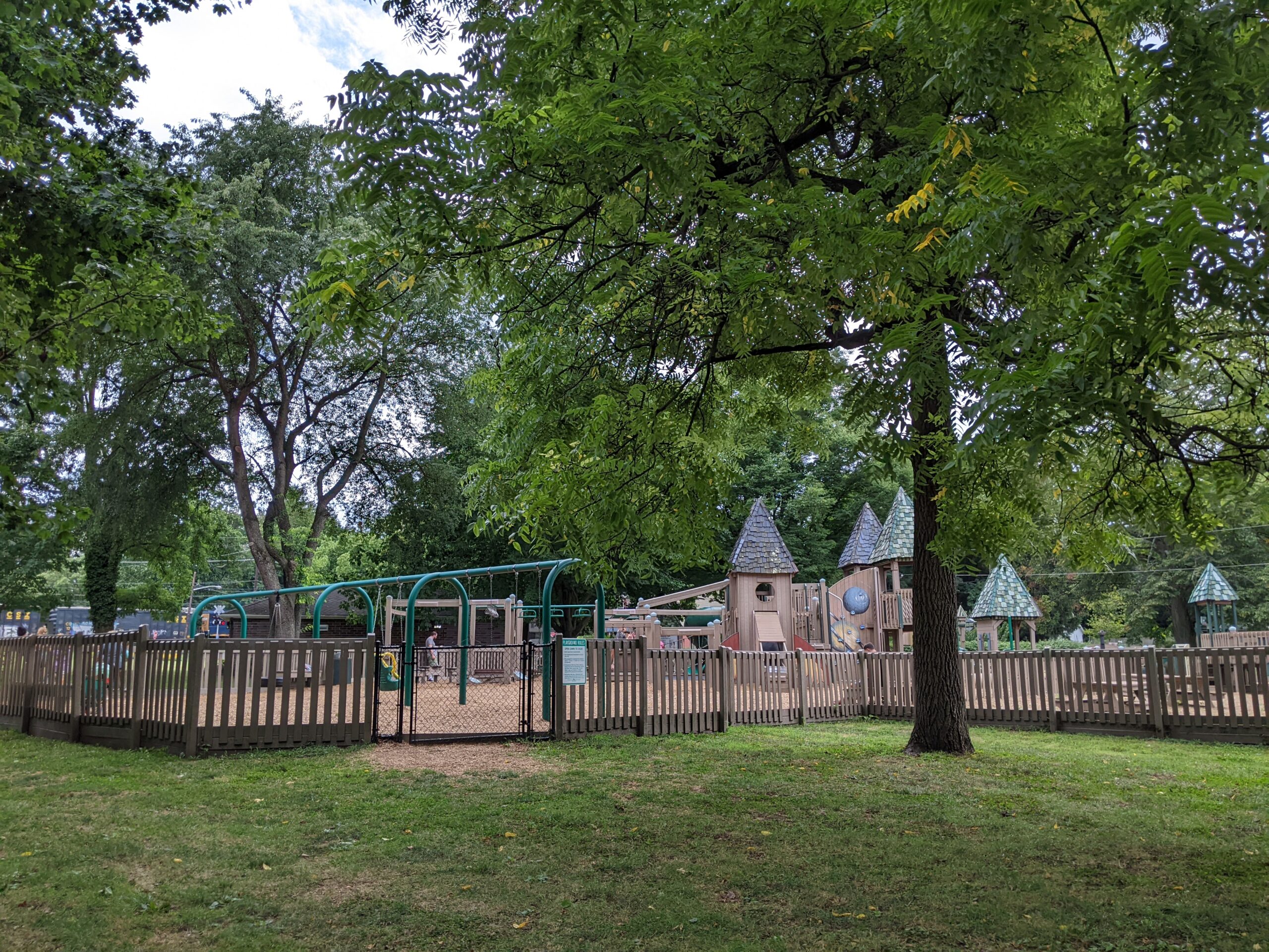 Frank Fullerton Memorial Park Playground in Moorestown NJ - WIDE image - back of playground with fencing