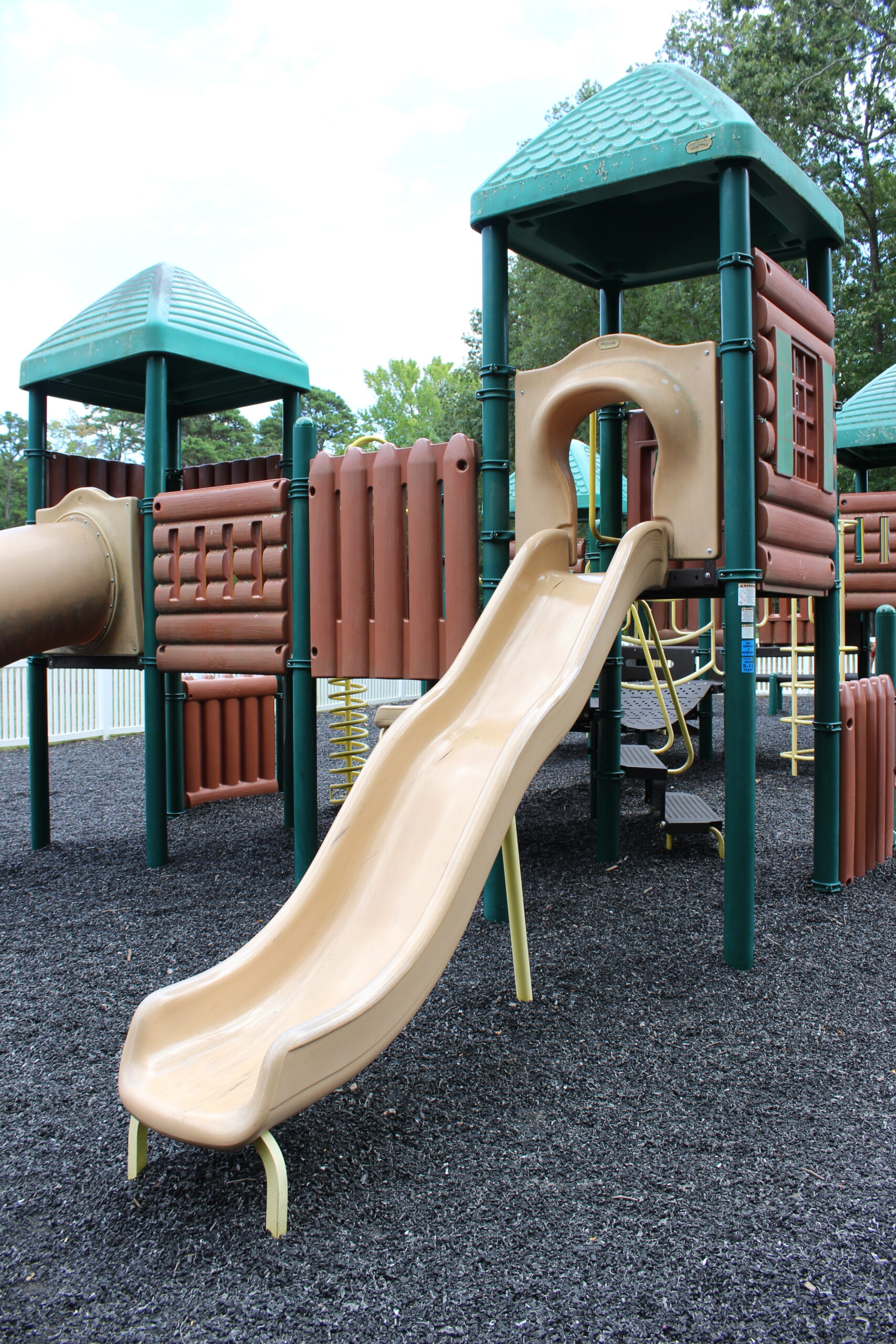 Front Estell Manor Park Playgrounds in Mays Landing NJ - SLIDES - open wavy slide on log cabin playground TALL image