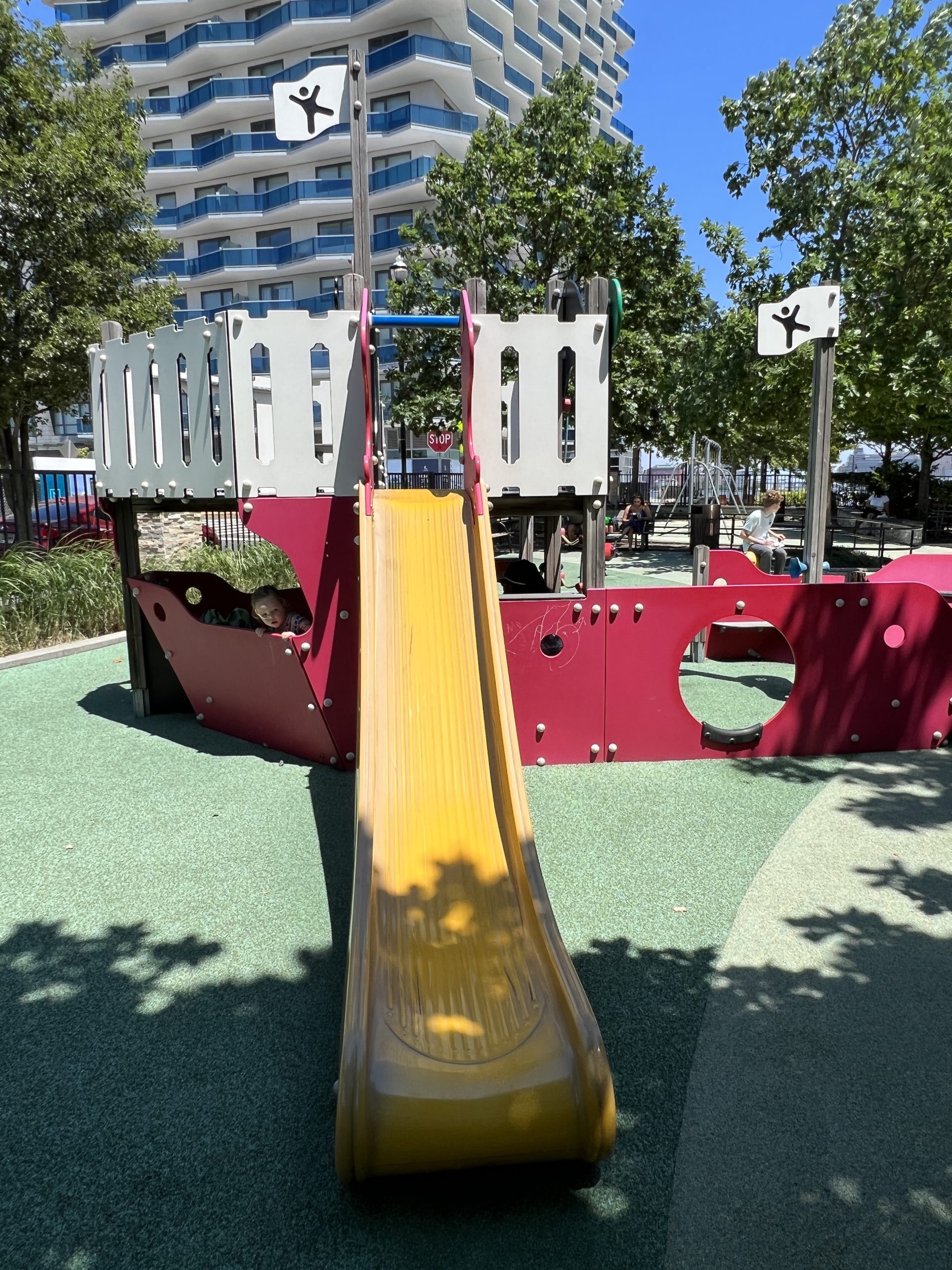 SLIDE - long straight yellow slide at ship playground AT Newport Green Park Playground in Jersey City NJ