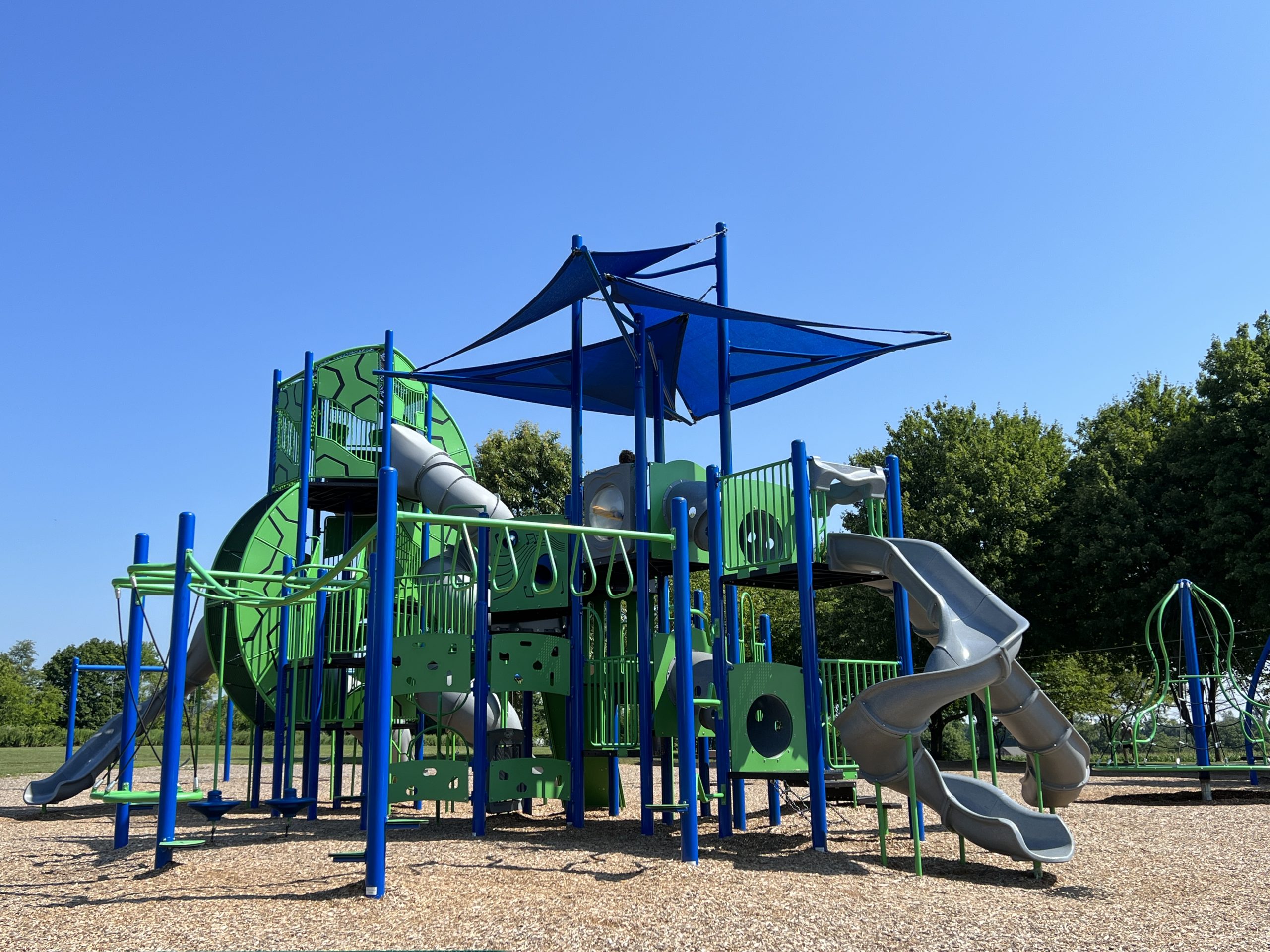 WIDE - Playground Structure with 1 spinner parking lot side At Heritage Park Playground in Asbury NJ