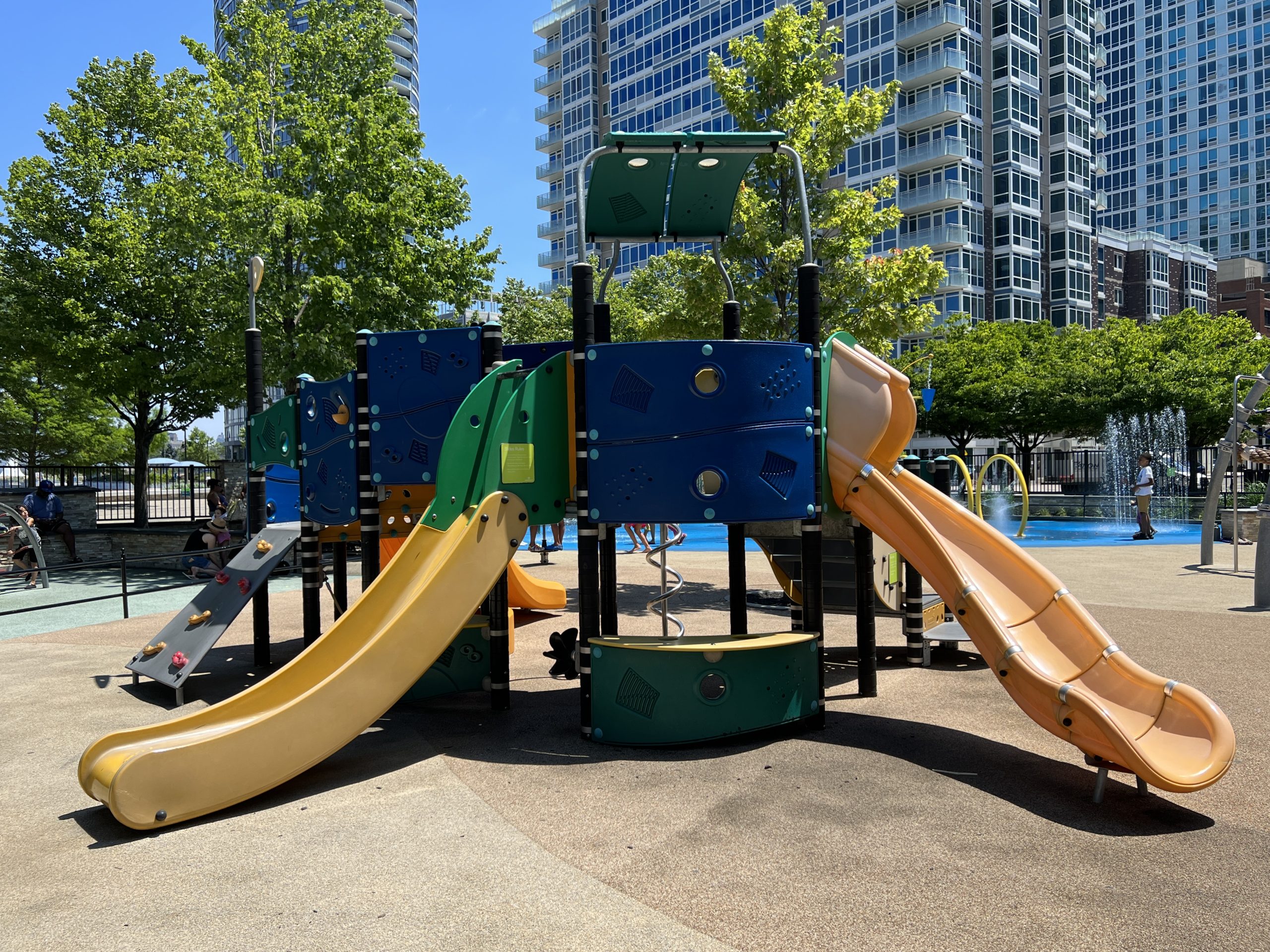 WIDE - multicolor playground side 2 with view of 2 slides. AT Newport Green Park Playground in Jersey City NJ