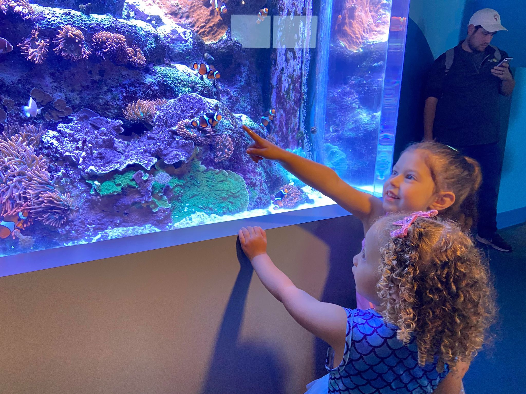 Two girls watching fish in Adventure Aquarium fish tank