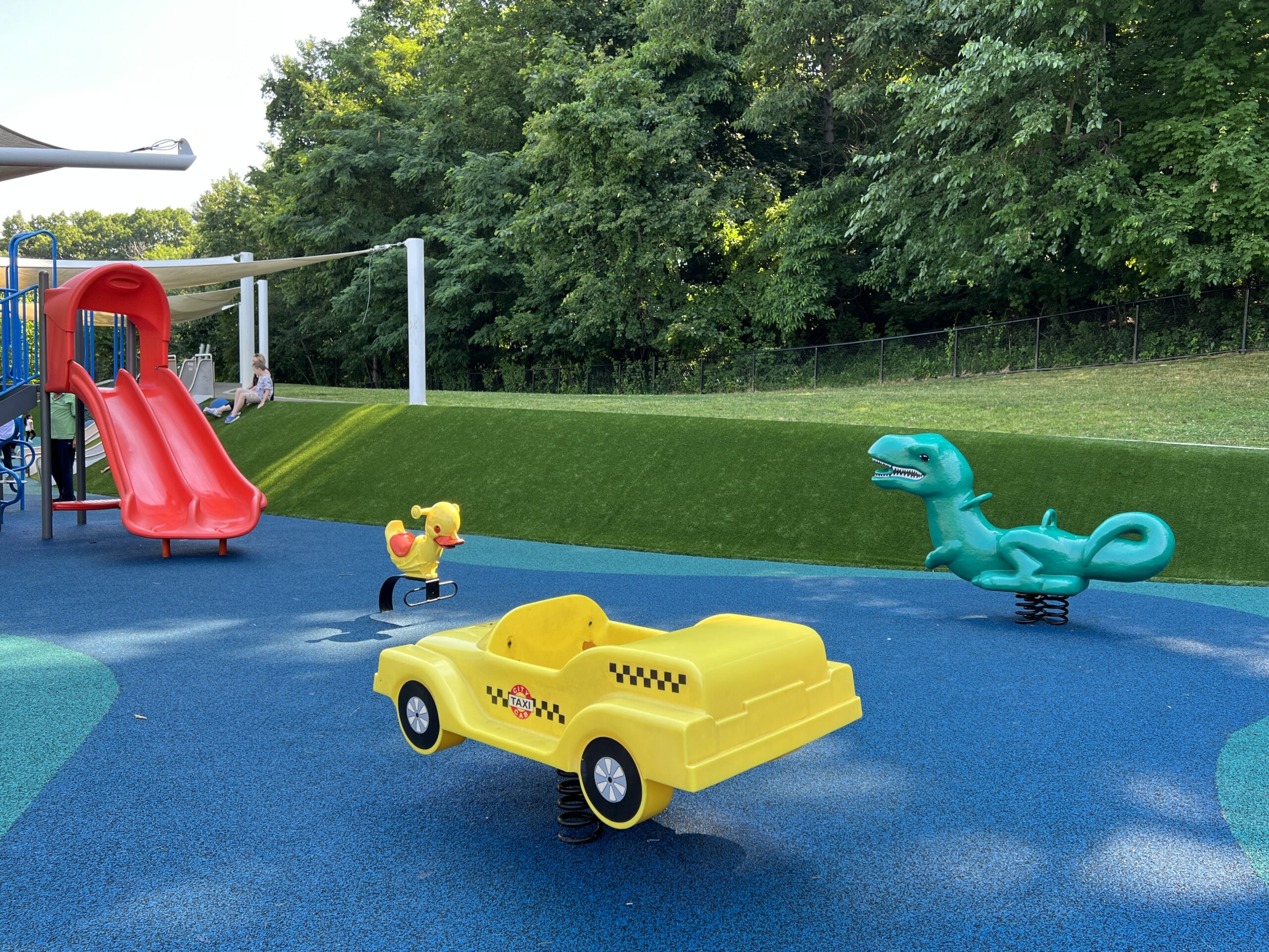 Verona Park Playground in Verona NJ - Features - Ride on toys taxi, dinosaur, and duck WIDE image